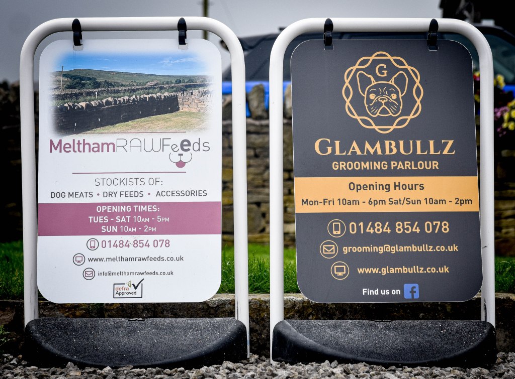 Glambullz Dog grooming parlour sign and Meltham Raw Feeds sign